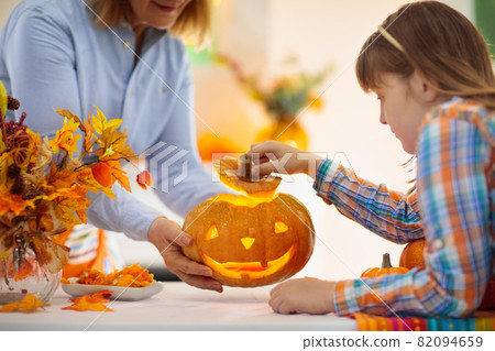 Family carving pumpkin for Halloween Family carving pumpkin for Halloween 82094659