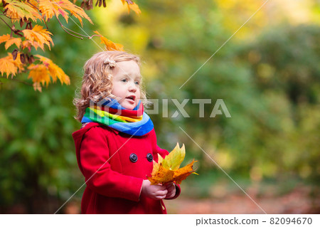 Little girl in autumn park. Child outdoor in fall. Little girl in autumn park. Child outdoor in fall. 82094670