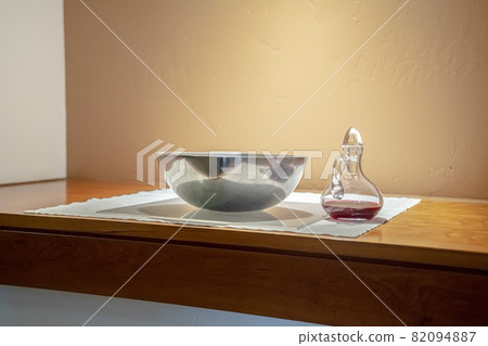 Red wine and bowl of wafers for Communion 82094887