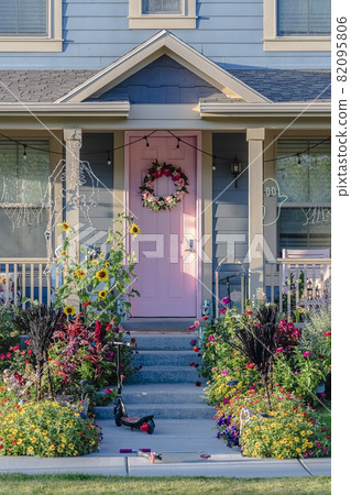 Kids scooter on a path in front of a house 82095806