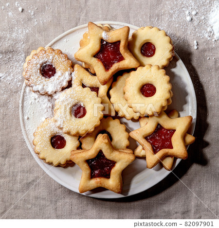Linz shortbread biscuits cookies with jam on linen tablecloth. Flat lay 82097901