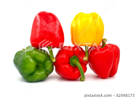 Red, green and yellow bell peppers on white Red, green and yellow bell peppers on white 82098173