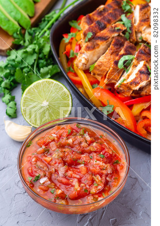Tex-Mex cuisine salsa Asada sauce with Chicken Fajitas, vertical 82098332