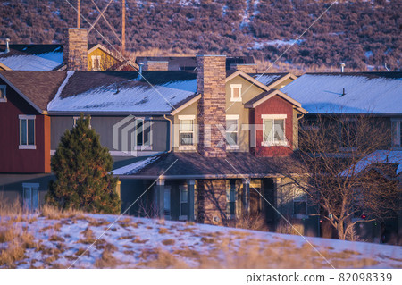 Houses in a winter landscape at sunset Houses in a winter landscape at sunset 82098339