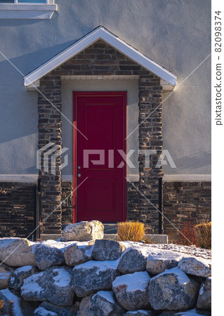 Bright red covered entrance door to a home 82098374
