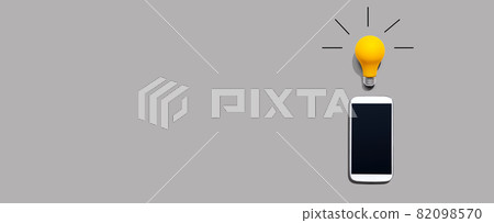 Smartphone with a yellow light bulb 82098570
