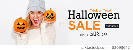 Halloween sale with woman holding pumpkins Halloween sale with woman holding pumpkins 82098642