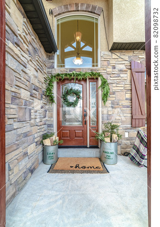 Front door to a house decorated with green wreath 82098732