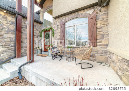 Exterior patio with two wicker comfy chairs Exterior patio with two wicker comfy chairs 82098733