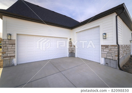 Two garage doors sharing a paved forecourt Two garage doors sharing a paved forecourt 82098830