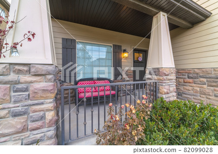 Front veranda with colourful red bench day light 82099028