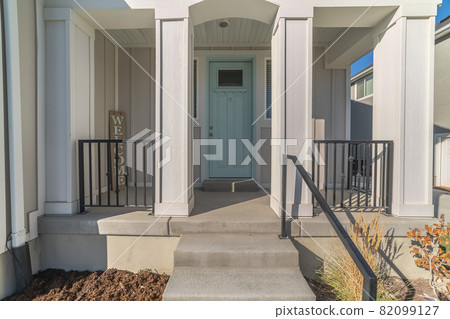 Steps with hand rail leading to a covered portico Steps with hand rail leading to a covered portico 82099127