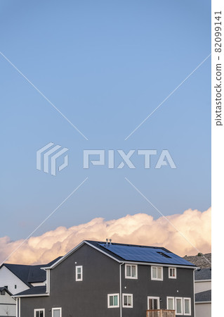 Dense white cloud formation behind a house 82099141