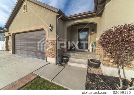 Covered house entrance with glass door day light 82099150