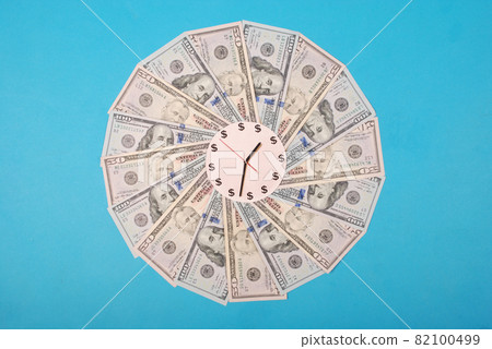 Concept of clock and dollar. Clock on kaleidoscope from money. Concept of clock and dollar. Clock on kaleidoscope from money. 82100499