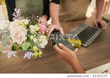 Woman Paying in Flower Shop 82101574