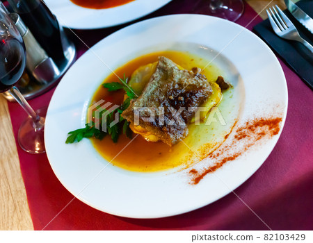 Tasty baked pork with potatoes and gravy 82103429
