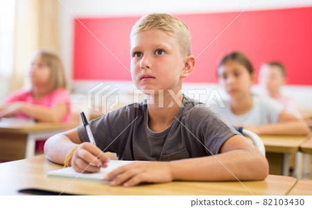 Boy sitting in classroom 82103430