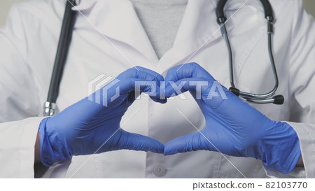 A doctor in blue gloves shows his heart, a cordiologist for a healthy outflow of blood, the services of a therapist in hospitals with the best specialists, it's time to examine the body for A doctor in blue gloves shows his heart, a cordiologist for a healthy outflow of blood, the services of a therapist in hospitals with the best specialists, it's time to examine the body for 82103770