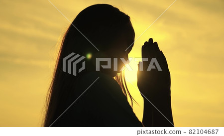 childhood dream of a happy childhood, silhouette of a teenager asking for help from God at sunset, praying for health at dawn, repenting of what he has done, faith in goodness and justice childhood dream of a happy childhood, silhouette of a teenager asking for help from God at sunset, praying for health at dawn, repenting of what he has done, faith in goodness and justice 82104687