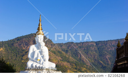 Wide view: A large white Buddha statue behind a mountain and a blue sky at Wat Pha Son Kaew, Khao Kho District, Phetchabun Province,thailand 82108268