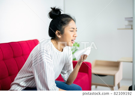 Sick woman with cold blowing and runny nose,Rhinitis people,Concept of healthcare,Sneezing women Sick woman with cold blowing and runny nose,Rhinitis people,Concept of healthcare,Sneezing women 82109192