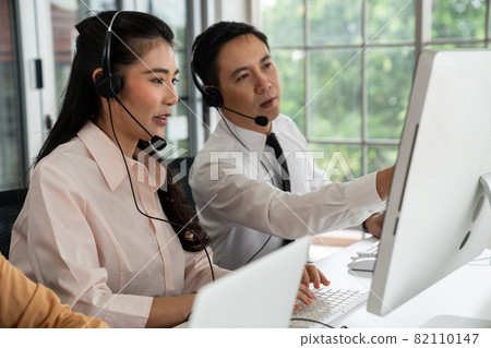 Business people wearing headset working actively in office 82110147