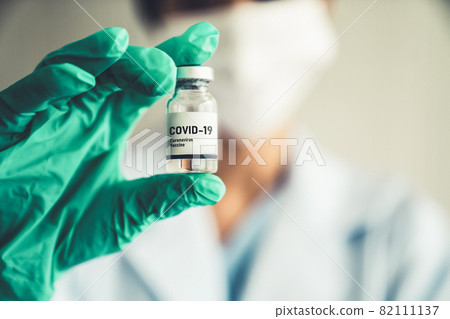 Skillful doctor prepare vaccine proficiently before injection Skillful doctor prepare vaccine proficiently before injection 82111137