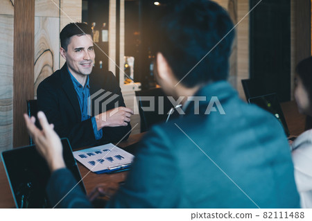 During a job interview, a man in a suit and gives a presentation about himself During a job interview, a man in a suit and gives a presentation about himself 82111488