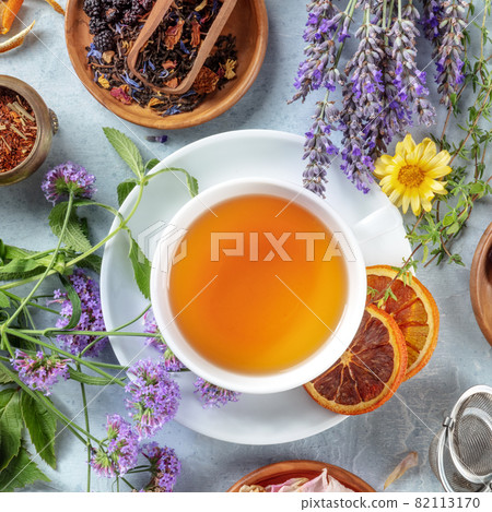 Tea with dry fruit, flowers, and herbs, square overhead shot with lavender Tea with dry fruit, flowers, and herbs, square overhead shot with lavender 82113170