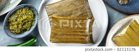 Tamales panorama. Traditional dish of Mexican cuisine, shot from above Tamales panorama. Traditional dish of Mexican cuisine, shot from above 82113176