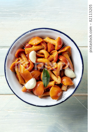 Pickled mushrooms with garlic and a bay leaf, shot from above 82113205