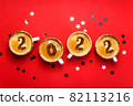New year 2022 is drawn on cups of coffee on red background 82113216