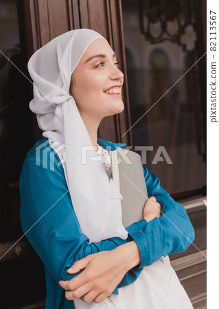 Young muslim girl wears hijab with diary book. Islamic student and knowledge concept. 82113567