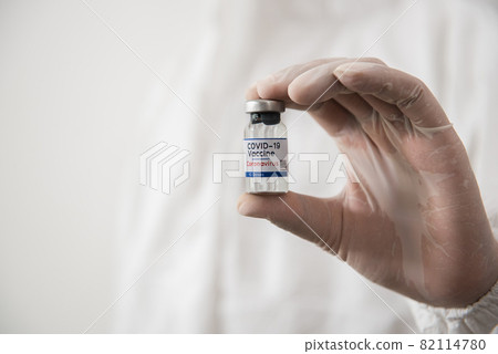 Doctor Hands in protective gloves holding covid-19 test dose. Doctor Hands in protective gloves holding covid-19 test dose. 82114780
