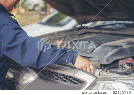 Mechanic car service auto garage in automotive mobile center. Technician workshop repair engine motor vehicles service mechanical engineering business. Automobile mechanic hands car repairs technic Mechanic car service auto garage in automotive mobile center. Technician workshop repair engine motor vehicles service mechanical engineering business. Automobile mechanic hands car repairs technic 82115789