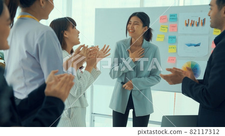 Businesswoman proficiently present work project receive celebrations from team Businesswoman proficiently present work project receive celebrations from team 82117312