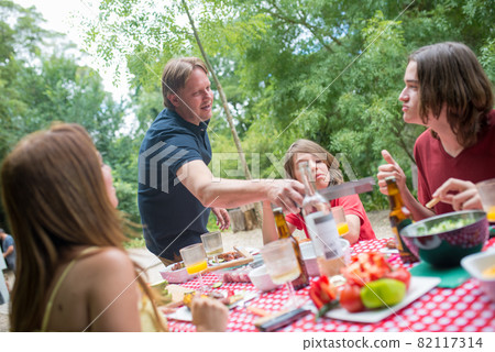 Cheerful family with children eating together Cheerful family with children eating together 82117314