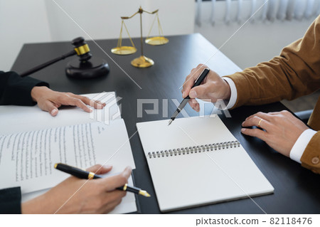 law,libra scale and hammer on the table, 2 lawyers are discussing about contract paper, law matters determination, showing paper and notes law,libra scale and hammer on the table, 2 lawyers are discussing about contract paper, law matters determination, showing paper and notes 82118476