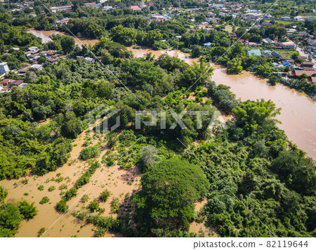 Aerial view river flood village countryside Asia and forest tree, Top view river with water flood from above, Raging river running down jungles lake flowing wild water after the rain 82119644