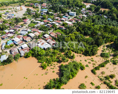 Aerial view river flood village countryside Asia and forest tree, Top view river with water flood from above, Raging river running down jungles lake flowing wild water after the rain Aerial view river flood village countryside Asia and forest tree, Top view river with water flood from above, Raging river running down jungles lake flowing wild water after the rain 82119645