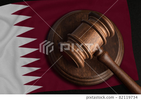 Judge Gavel and flag of Qatar. Law and justice in Qatar. Violation of rights and freedoms Judge Gavel and flag of Qatar. Law and justice in Qatar. Violation of rights and freedoms 82119734