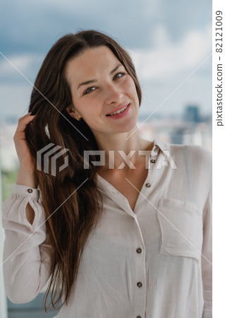 Portrait of young caucasian woman outdoors, looking at camera. Portrait of young caucasian woman outdoors, looking at camera. 82121009