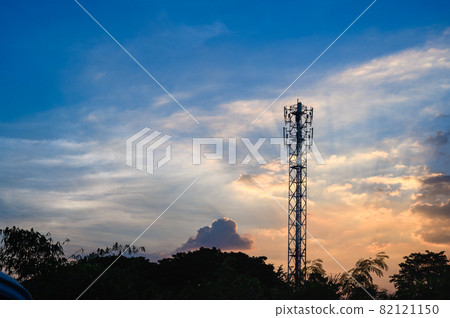 Silhouette of Tower antenna transmission. Repeater of communication and telecommunication with beautiful cloudy sky at sunset on background with copy space. Silhouette of Tower antenna transmission. Repeater of communication and telecommunication with beautiful cloudy sky at sunset on background with copy space. 82121150