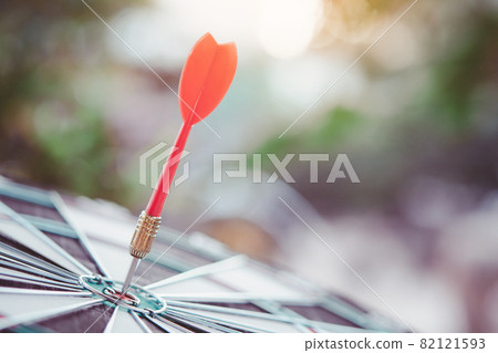 Business marketing success concept. Red dart arrow in center of the target dartboard. Bullseye is a target of business. Business marketing success concept. Red dart arrow in center of the target dartboard. Bullseye is a target of business. 82121593