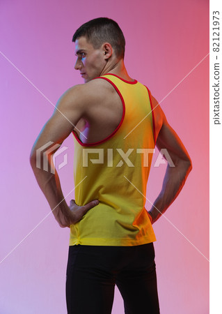 Back view portrait of young male professional athlete isolated over gradient studio background Back view portrait of young male professional athlete isolated over gradient studio background 82121973
