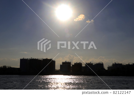 Silhouette, Back view of oil storage tanks in the export port, the oil business that exports by ships. Silhouette, Back view of oil storage tanks in the export port, the oil business that exports by ships. 82122147