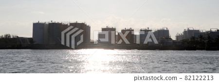 Silhouette, Back view of oil storage tanks in the export port, the oil business that exports by ships. Silhouette, Back view of oil storage tanks in the export port, the oil business that exports by ships. 82122213