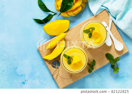 Homemade dessert panna cotta with mango jelly. Copy space, top view flat lay background. Traditional italian dessert. Homemade dessert panna cotta with mango jelly. Copy space, top view flat lay background. Traditional italian dessert. 82122825