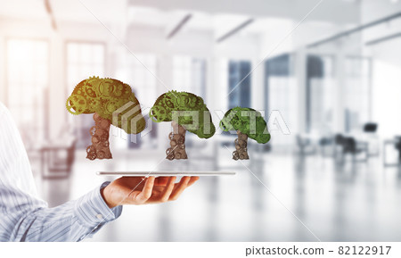 Eco green environment concept presented by tree as working mechanism or engine Eco green environment concept presented by tree as working mechanism or engine 82122917